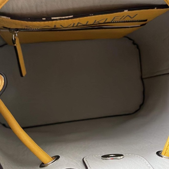 Interior picture of yellow Calvin Klein bag. Noticed flaw on interior - Picture 9 of 9